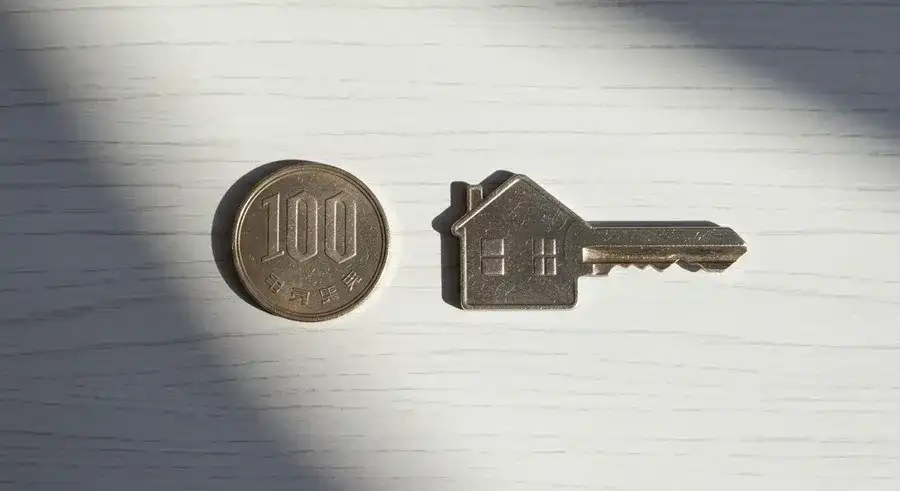 ダイソー防犯ステッカーのコスパを示す100円玉と家の鍵